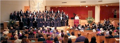 Swami Adiswarananda at podium addressing the congregation.