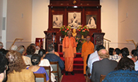 Swami Prameyanandaji and Swami Adiswarananda standing in front of the Altar
