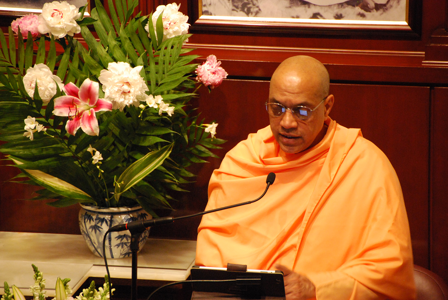 swami yuktatmananda speaking at a podium
